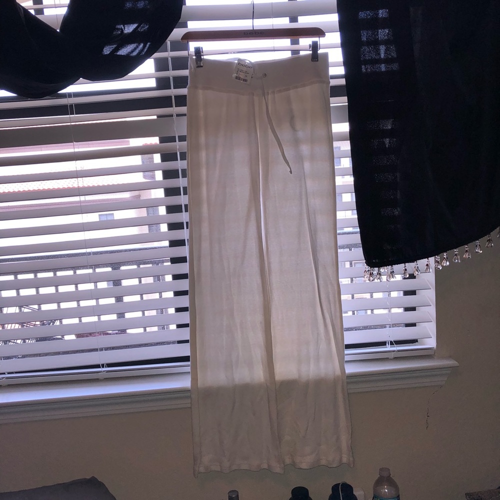 BEBE WORK OUT PANTS W LOGO ON A HANGER
